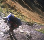 Approaching Abra de Warmiwa�usqa (Dead Woman Pass) at 4200m, a porter struggles under an enormous load of gear that tourists refuse to carry; this is the highest point on the Inca Trail