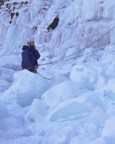 Chris belys Tommy in a field of blue ice blocks; while following the route, enormous ice blocks released, completely burying this belay spot in tons of fresh ice